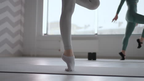 Close-up-of-a-female-ballerina-walking-on-socks-without-pointe-shoes.-Training-of-the-feet-of-women-ballerinas-in-slow-motion